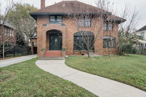 Classic two-story brick home with elegant curb appeal and a large front lawn