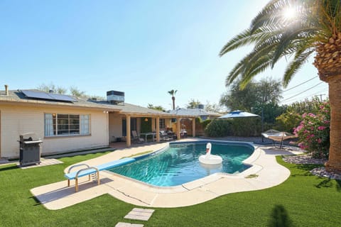 Take the plunge off the diving board into the sparkling pool, then dry off under the covered patio's fire pit lounge or challenge someone to ping pong, with a hammock and lush grass rounding out this private backyard retreat.