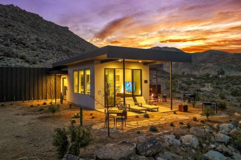 Modern desert retreat with mountain views and a glowing sunset patio