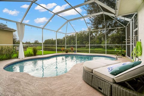 Take a dip in your own screened-in pool, tucked away next to a small lake on the border of the Cypress Creek Nature Preserve.