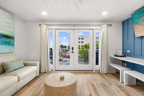 Relax in a bright, open living room w/ beautiful beach views, a brand-new leather sofa, premium gel queen sleeper, + 65” Smart TV.

Thoughtfully renovated for comfort, style, + functionality, it’s the perfect place to unwind after a day at the beach.