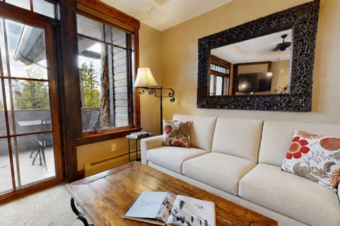 Unwind in your inviting living room with cozy seating, warm wood accents, and doors opening to your private balcony. Natural light and thoughtful décor create the perfect retreat.