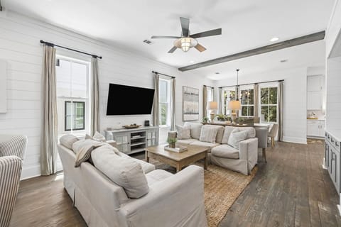 Relax in your open-concept living space with vaulted ceilings, modern farmhouse charm, and comfortable seating perfect for unwinding after exploring the area.