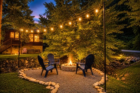 Gather around the fire pit beside a peaceful creek and enjoy your own private outdoor retreat. Surrounded by trees and tucked behind the cabin, this cozy space offers the perfect setting for a relaxing night.