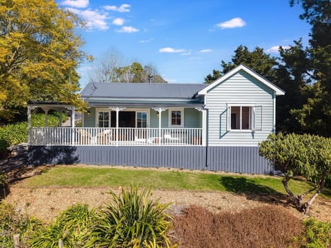Exterior of the Saddlers Cottage, a charming rural retreat surrounded by greenery and open countryside