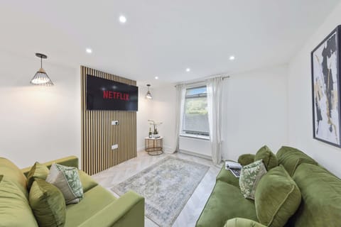 Settle into the bright and stylish living room after a day exploring, with comfortable seating, a large Smart TV and plenty of space to relax together.