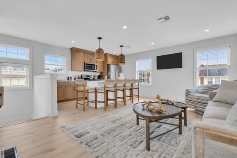 Bright open living space with modern kitchen island and cozy lounge