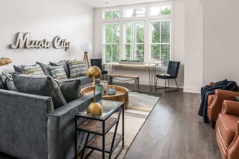Welcome to East Nashville — walk to Grimey's, Living Water Brewery, and Elegy Coffee from this bright, music-inspired living room.