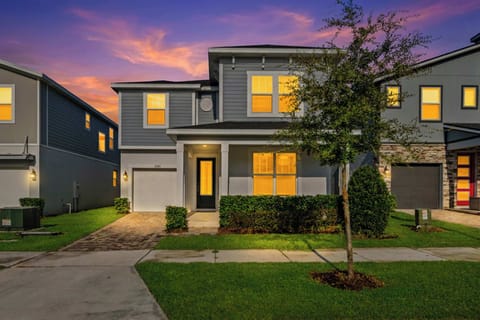 Welcome to this stylish modern home with crisp gray siding, a bright front porch, and a manicured lawn-an inviting first impression in a beautiful neighborhood.