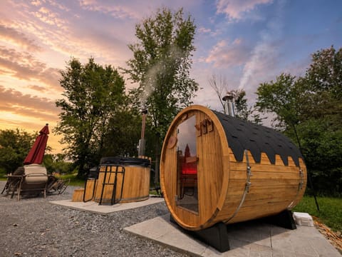 Private sauna and hot tub retreat under a stunning sunset sky
