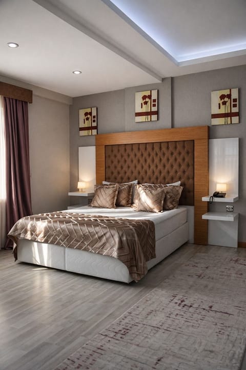 Deluxe Quadruple Room | In-room safe, desk, laptop workspace, blackout drapes