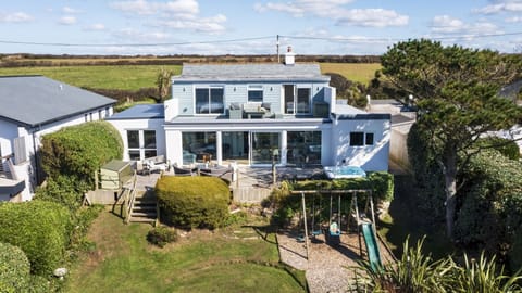 Aerial view of Fourburrows with garden and sea views in Mawgan Porth Cornwall with Forever Cornwall