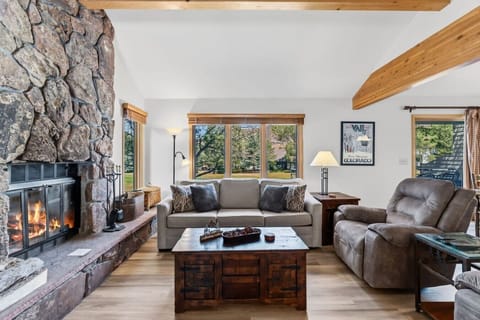 Cozy living area with wood-burning fireplace and smart TV