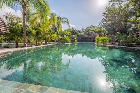 Dive into the resort-style swimming pool surrounded by lush tropical landscaping, perfect for cooling off under the Caribbean sun.