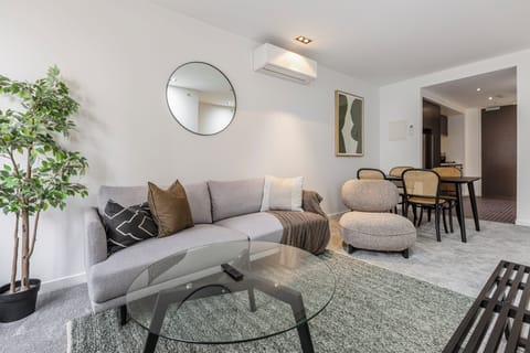 The decor pairs soft neutral furnishings with contemporary styling, creating a calm setting to settle in after a day exploring the city.