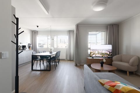 The living room and kitchen are one open space. Access to the downstairs balcony is from living room