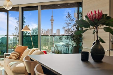 Enjoy Sky Tower and city views from the living and dining area
