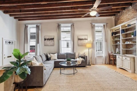 Living Room | Lounge Area with Exposed Beam Ceiling and Natural Light | Third Floor of Building — Unit on One Level