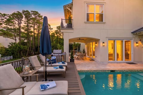Twilight by the pool sets the scene for relaxed evenings, with loungers, a grill, and covered outdoor dining just steps away.
