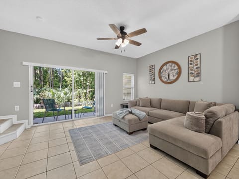 Spacious Downstairs Living Area with Comfortable Seating and Back Patio