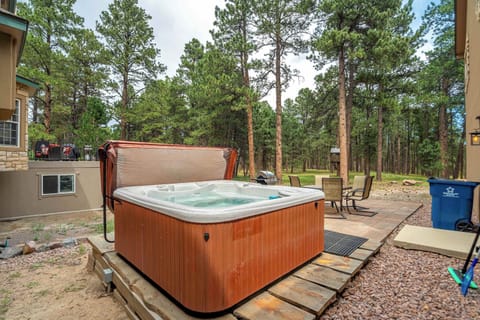 Welcome to Ponderosa Woods! The shared hot tub sits at the edge of the stone patio with tall ponderosa pines standing close behind it. Evenings out here run quiet and cool, and dark enough to watch the stars come out at night.