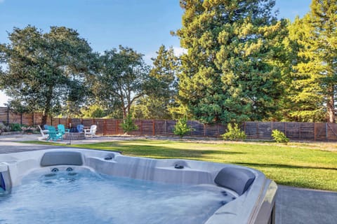 The Gravenstein opens to a private backyard where you can soak in the hot tub and look out over the lawn and tree-lined fence.