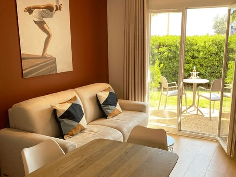 Living room with couch and outdoor terrace view.
