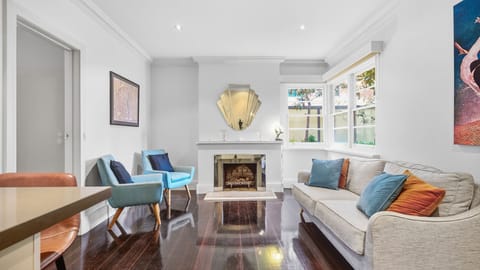 Bright and inviting living room layout with comfortable sofa seating.