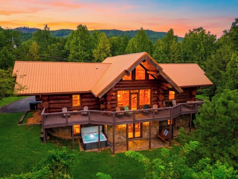 Log cabin exterior surrounded by lush trees.