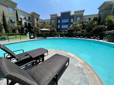 Refreshing swimming pool with sun loungers and a serene atmosphere.