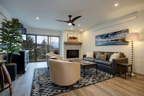 Sink into the plush seating and unwind by the fireplace in this beautifully designed living room, where natural light and thoughtful touches make your getaway feel like home.