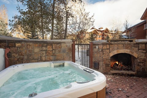 Slip into the bubbling hot tub on your private patio, where a crackling outdoor fireplace and mountain views create the perfect après-ski retreat.