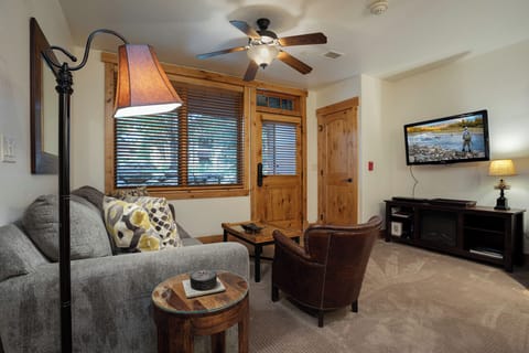Curl up in your cozy living room with plush seating, warm wood accents, and a ceiling fan keeping you comfortable. Stream your favorite shows or simply unwind after a day of adventure.