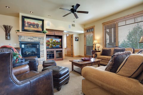Settle into plush seating by your cozy stone fireplace—perfect for unwinding after a day of adventure. Rich wood accents and natural light create a warm mountain retreat you'll love coming home to.