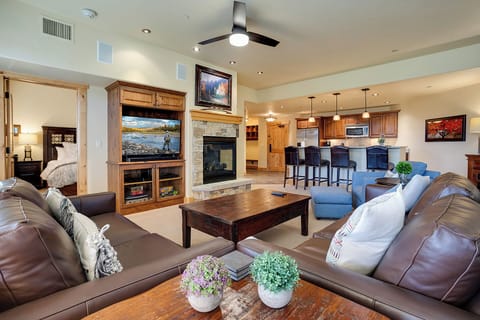 Unwind in this inviting open-concept space where plush seating and a glowing fireplace create the perfect retreat after your mountain adventures.