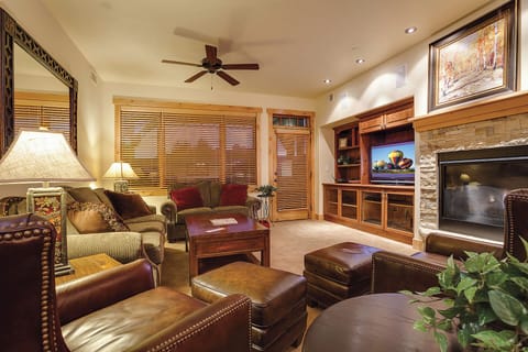 Sink into plush leather seating and unwind in your inviting living space, complete with a warm fireplace, entertainment center, and rich wood details that create the perfect mountain retreat atmosphere.