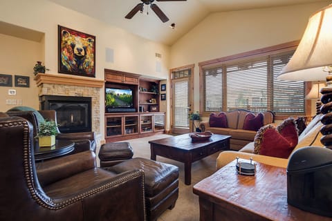 Sink into plush leather seating by the warm fireplace, perfect for evenings after exploring. Enjoy your favorite shows on the big screen while mountain light filters through the windows.