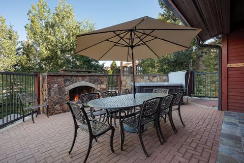 Dine al fresco at your private patio table, surrounded by mature trees and mountain views. Warm up by the outdoor stone fireplace or unwind in the hot tub after a day of adventure.