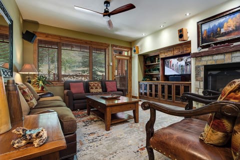 Unwind in your cozy living room with plush seating, a warm fireplace, and entertainment center—your perfect retreat after exploring the mountains.