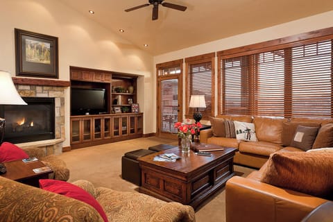 Sink into plush seating by the warm fireplace, gather around the rich wood coffee table, and enjoy your favorite shows on the entertainment center—your perfect mountain retreat awaits.