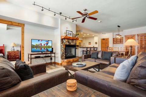 Sink into plush leather sofas and unwind by your stone-accented fireplace, with wood details and thoughtful touches creating your mountain retreat haven.
