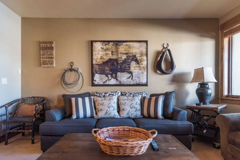 Sink into plush seating surrounded by warm rustic charm, where equestrian artwork and thoughtful touches create your peaceful retreat after a day of adventure.