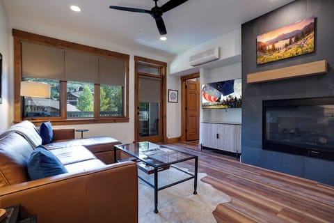 Settle into your cozy living space with leather seating, a glowing fireplace, and entertainment ready to go. Natural light and mountain art invite you to relax after your adventures.