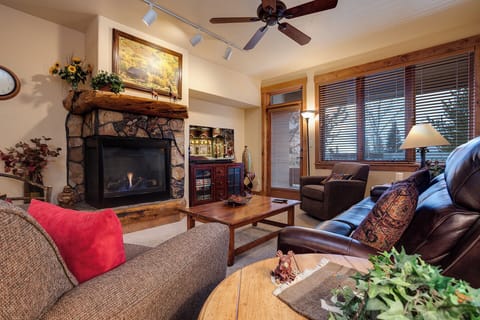 Sink into plush leather sofas beside a warm stone fireplace, while mountain views peek through the windows—your perfect après-ski retreat awaits.