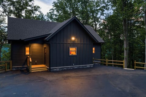 This is where mountain evenings begin. Two levels of outdoor living, warm cabin interiors, a private hot tub, and barrel sauna tucked into the woods.