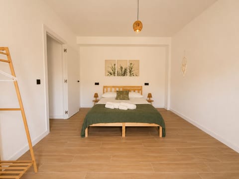 Bright minimalist bedroom with warm wood accents and a calming, airy feel