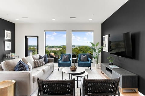 Spacious living room with queen pull-out couch, stunning riverfront views, and a Smart TV for your entertainment. Enjoy your morning coffee on our private patio that overlooks Cumberland river.