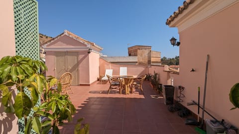 A wide terrace with dining and lounge seating for soaking up the sun.