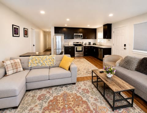 Bright open living space with comfy seating and a modern full kitchen