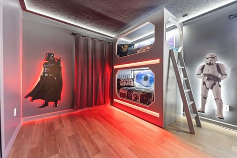 Step into this custom-designed bedroom where movie magic comes alive. The built-in bunk bed creates an adventurous hideaway, while dramatic LED lighting and themed décor make bedtime an epic adventure.